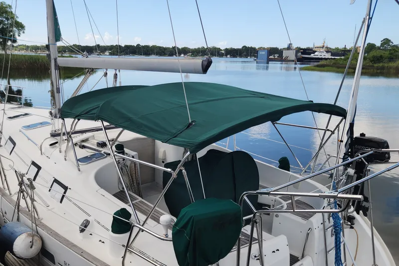 Slide: The Image of 1999 Beneteau Oceanis 411 Celebration sailboat docked with green canopy. - 6