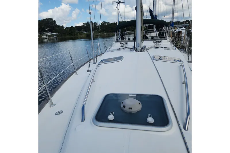 Slide: The Image of Beneteau Oceanis 411 Celebration 1999 sailboat deck view on calm water. - 10