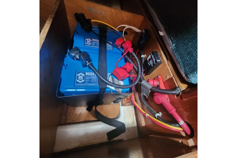 Slide: The Image of Battery compartment of a 1999 Beneteau Oceanis 411 Celebration sailboat, featuring blue DC batteries. - 34