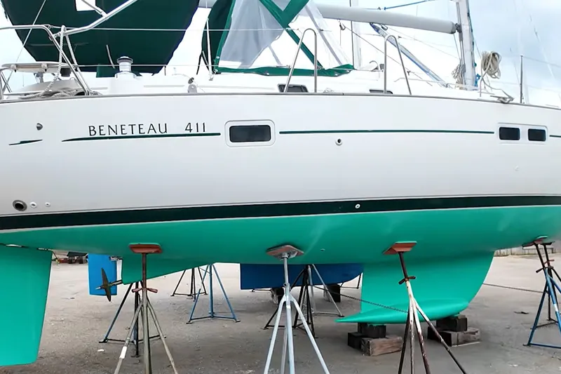 Slide: The Image of (sistership) 1999 Beneteau Oceanis 411 Celebration sailboat on stands, showcasing hull and keel. - 4