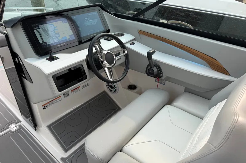 Slide: The Image of 2024 Regal LS9 boat cockpit with modern steering, dual screens, and sleek interior design. - 20