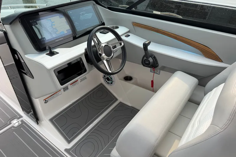 Slide: The Image of 2024 Regal LS9 boat cockpit with modern steering, dual screens, and sleek interior design. - 19