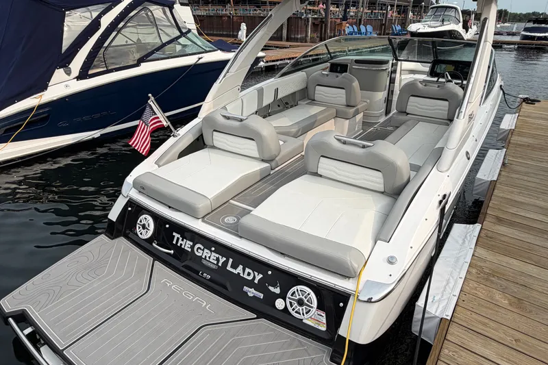 Slide: The Image of 2024 Regal LS9 luxury boat docked, featuring spacious seating and sleek design. - 5