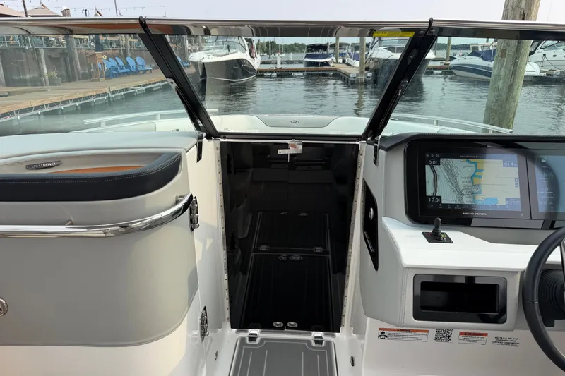 Slide: The Image of 2024 Regal LS9 boat interior with navigation display, docked at marina. - 31