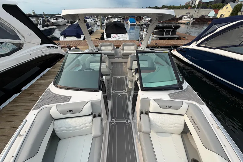 Slide: The Image of 2024 Regal LS9 boat interior at marina, featuring sleek seating and modern design. - 36