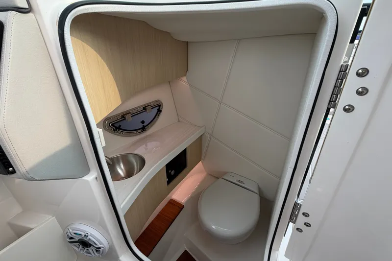 Slide: The Image of 2024 Regal LS9 boat interior bathroom with sink and toilet. - 29