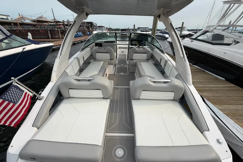 Slide: The Image of 2024 Regal LS9 boat interior with spacious seating, docked at marina. - 6