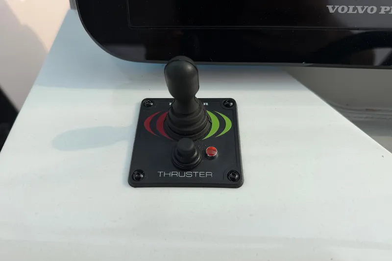 Slide: The Image of Joystick control panel on a 2024 Regal LS9 boat, labeled "Thruster." - 24