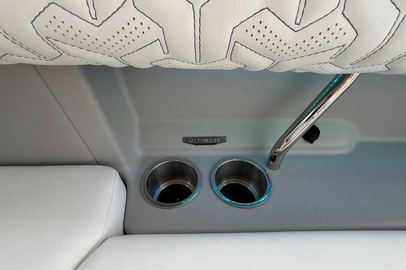 Slide: The Image of 2024 Regal LS9 interior detail with white upholstery, cup holders, and chrome handle. - 17