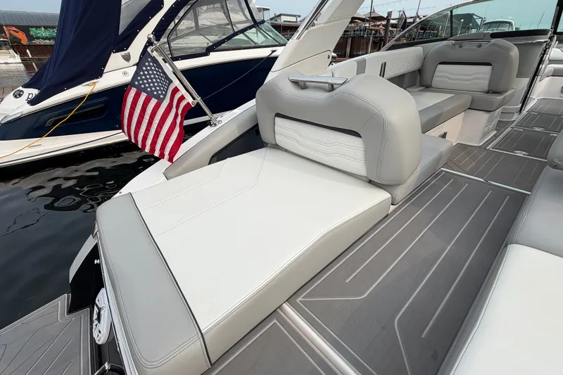 Slide: The Image of 2024 Regal LS9 boat interior with American flag, featuring sleek gray and white seating. - 9