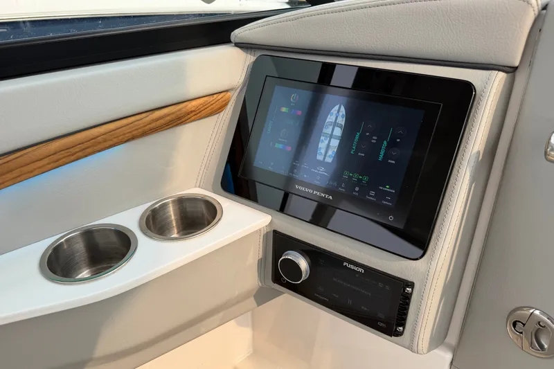 Slide: The Image of 2024 Regal LS9 boat interior with touchscreen display and dual cup holders. - 28