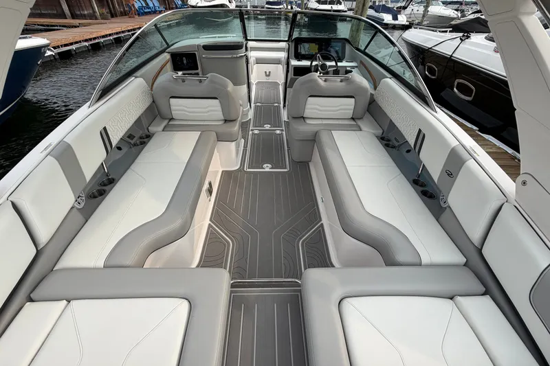 Slide: The Image of 2024 Regal LS9 boat interior with luxurious seating and modern design at a marina. - 10
