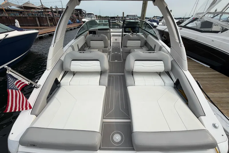 Slide: The Image of 2024 Regal LS9 luxury boat interior with spacious seating and elegant design at a marina. - 7