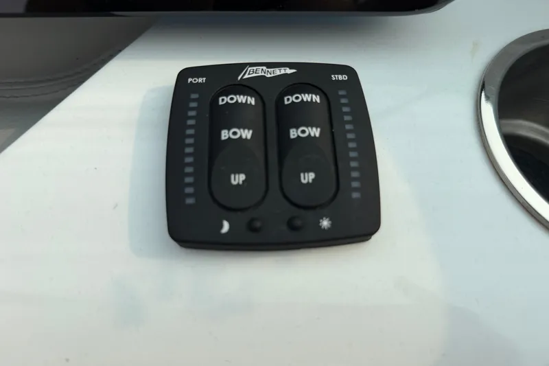 Slide: The Image of Bennett trim tab control panel on 2024 Regal LS9 boat dashboard. - 23