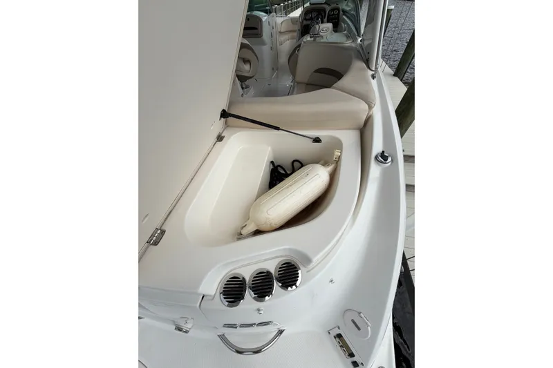 Slide: The Image of 2007 Chaparral 256 SSi boat interior with open storage compartment and fender. - 17