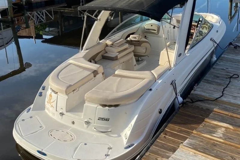 Slide: The Image of 2007 Chaparral 256 SSi boat docked, featuring spacious seating and a sleek design. - 23