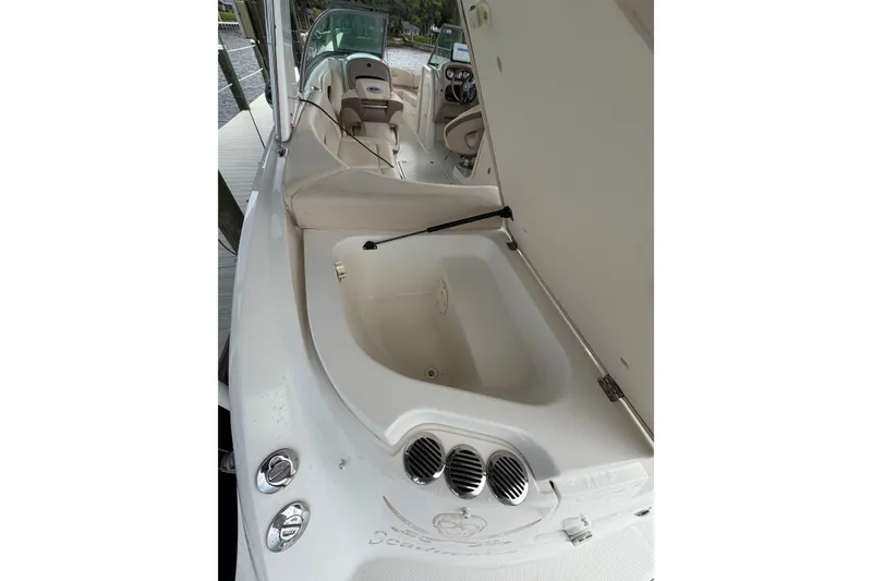 Slide: The Image of 2007 Chaparral 256 SSi boat interior with open storage compartment and seating area. - 18