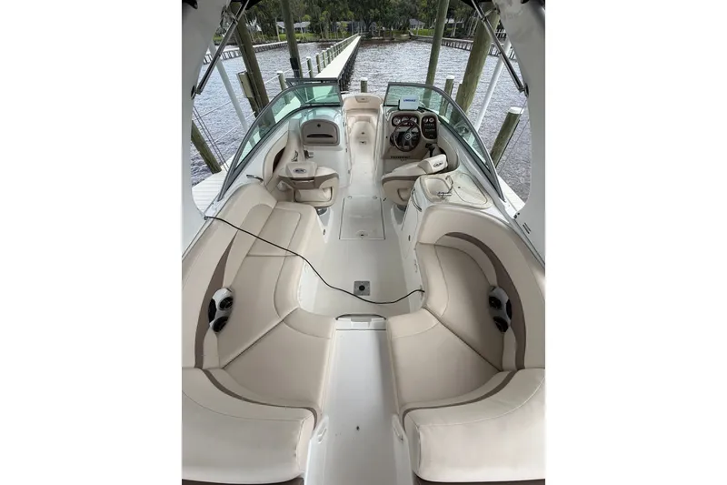 Slide: The Image of Interior view of 2007 Chaparral 256 SSi boat with beige seating and dashboard. - 16