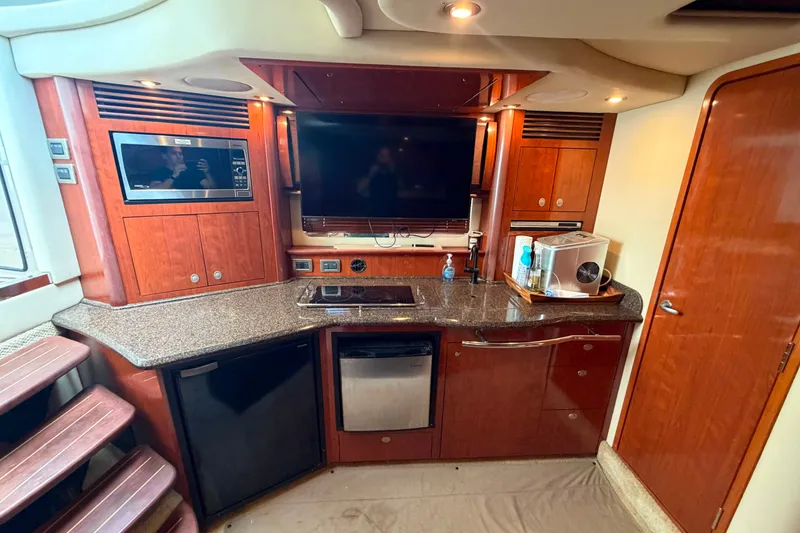 Slide: The Image of Luxurious 2006 Sea Ray 40 Sundancer yacht interior with modern kitchen amenities. - 14
