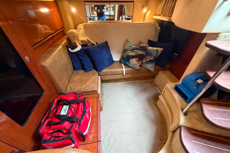 Slide: The Image of Interior of 2006 Sea Ray 40 Sundancer yacht with seating, cushions, and a red bag. - 13