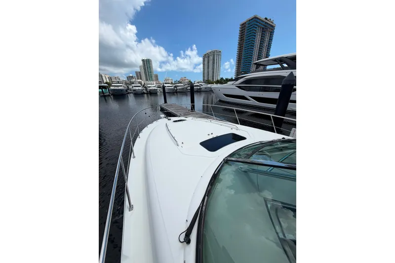 Slide: The Image of 2006 Sea Ray 40 Sundancer yacht docked in a marina with city skyline. - 17