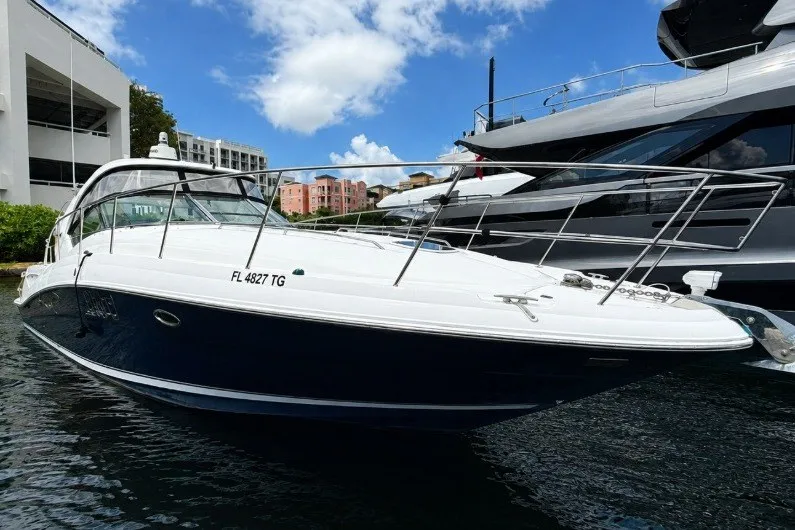 The Image of 2006 Sea Ray 40 Sundancer yacht docked in marina under blue sky. - 0