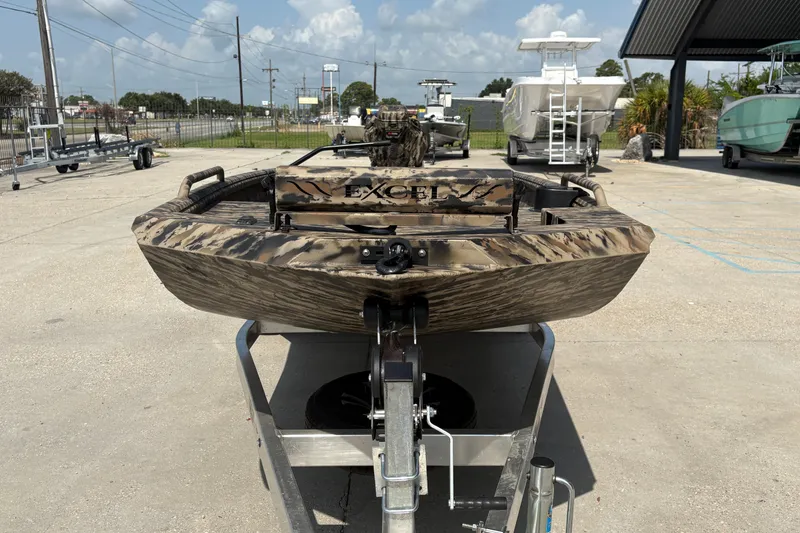 Slide: The Image of 2026 Excel 1751 Shallow Water F4 boat on trailer, camo design, outdoor display. - 10