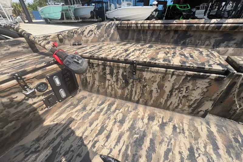 Slide: The Image of 2026 Excel 1751 Shallow Water F4 boat interior with camouflage design and control panel. - 19