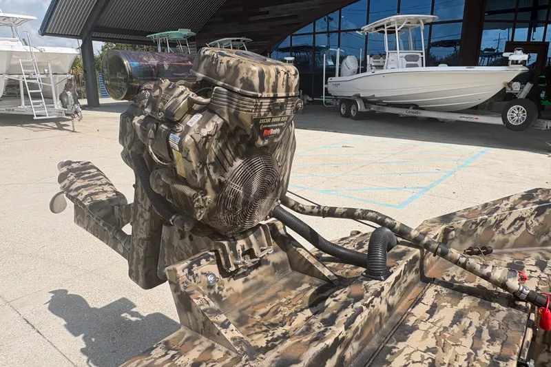 Slide: The Image of Camouflage-patterned Excel 1751 Shallow Water F4 boat engine, 2026 model, displayed outdoors. - 13