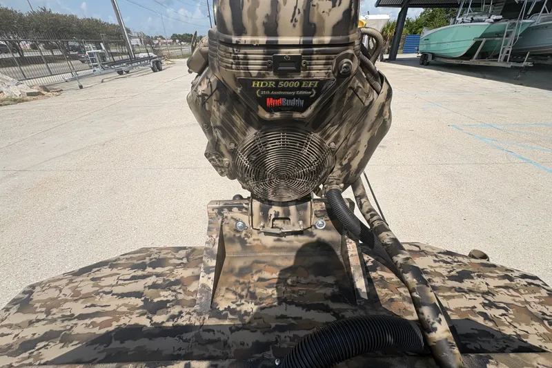 Slide: The Image of Camouflage-patterned Excel 1751 Shallow Water F4 boat engine, 2026 model, parked outdoors. - 21