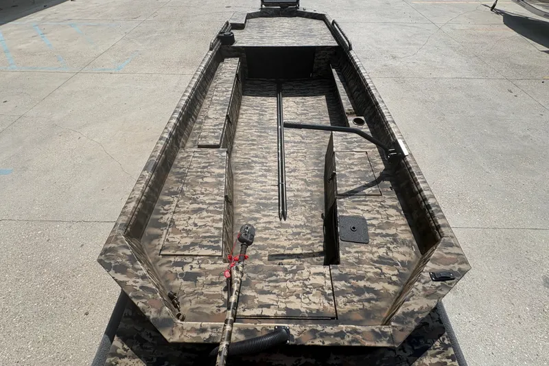 Slide: The Image of 2026 Excel 1751 Shallow Water F4 boat with camouflage design on concrete surface. - 14