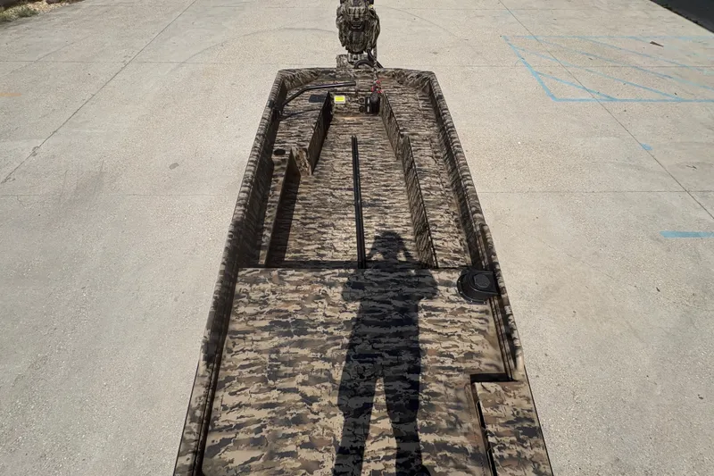 Slide: The Image of 2026 Excel 1751 Shallow Water F4 boat with camouflage design on concrete surface. - 22