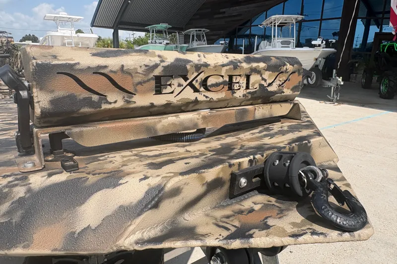 Slide: The Image of 2026 Excel 1751 Shallow Water F4 boat with camouflage design, displayed outdoors. - 12