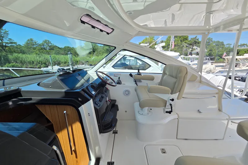 Slide: The Image of 2023 Tiara Yachts 4300 Open helm with modern controls and luxurious seating. - 14