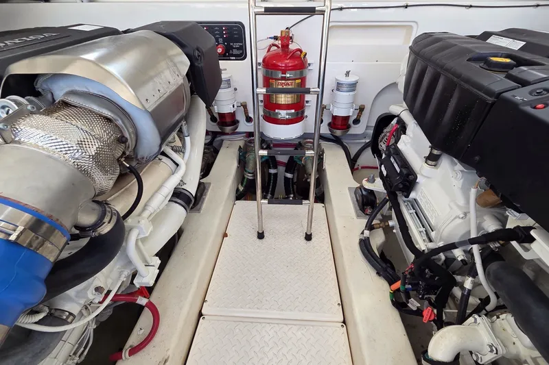 Slide: The Image of Engine room of 2023 Tiara Yachts 4300 Open, featuring dual engines and fire extinguisher. - 30