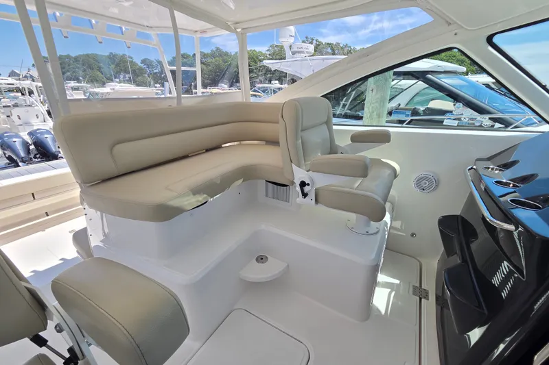 Slide: The Image of 2023 Tiara Yachts 4300 Open interior with beige seating and helm station. - 16