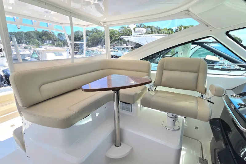 Slide: The Image of Luxurious seating area on 2023 Tiara Yachts 4300 Open, featuring plush beige upholstery. - 17