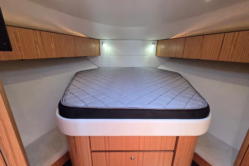 Slide: The Image of 2023 Tiara Yachts 4300 Open cabin interior with bed and wooden cabinetry. - 24