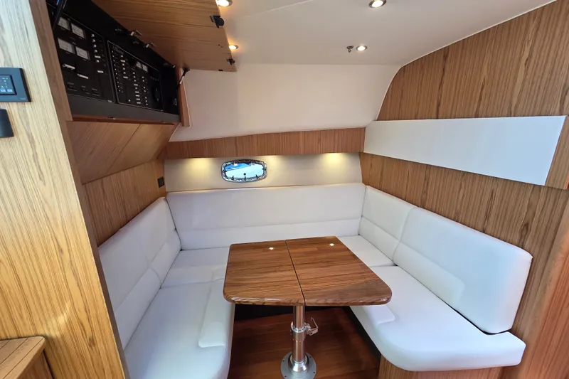 Slide: The Image of Luxurious interior of 2023 Tiara Yachts 4300 Open with elegant wood and white seating. - 21