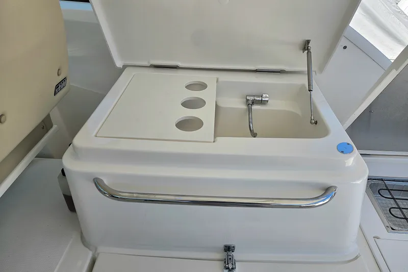 Slide: The Image of 2023 Tiara Yachts 4300 Open yacht sink with faucet and storage compartments. - 13