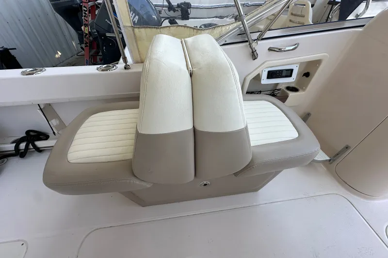 Slide: The Image of 2014 Grady-White Tournament 225 boat seating with beige and white upholstery. - 15