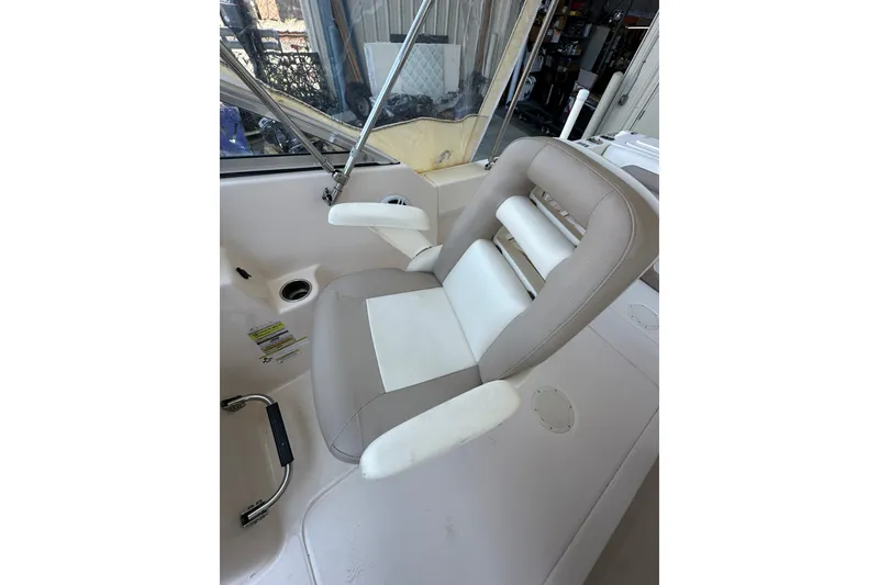 Slide: The Image of 2014 Grady-White Tournament 225 boat seat with beige and white upholstery. - 14