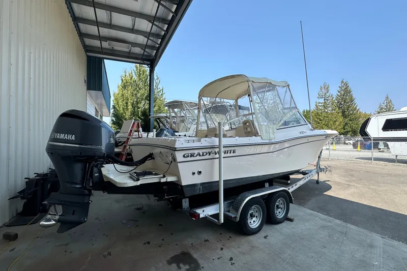 The Image of 2014 Grady-White Tournament 225 boat on trailer with Yamaha outboard motor. - 1