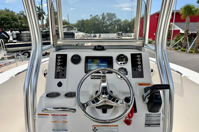 Slide: The Image of 2017 Robalo R200 Center Console boat dashboard with steering wheel and controls. - 17