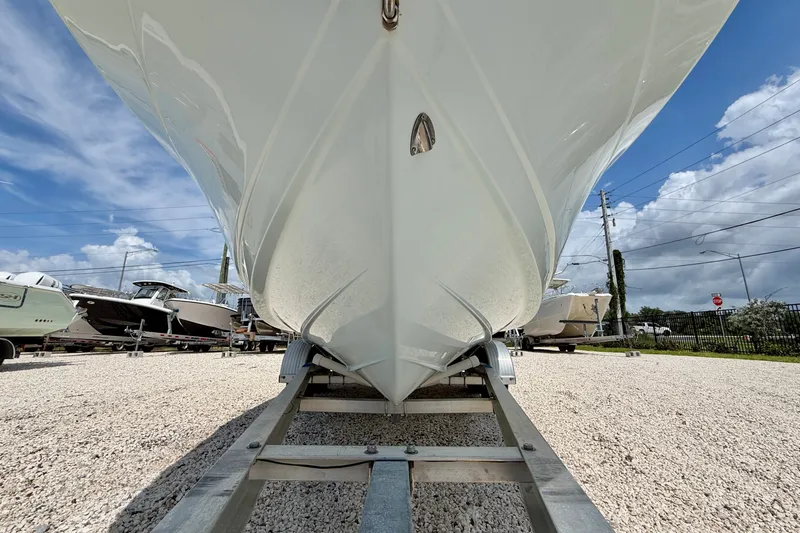 Slide: The Image of 2017 Robalo R200 Center Console boat on trailer, under clear blue sky. - 24