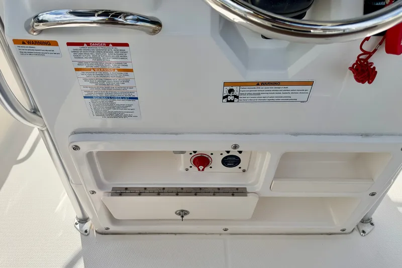 Slide: The Image of 2017 Robalo R200 Center Console dashboard with warning labels and controls. - 25