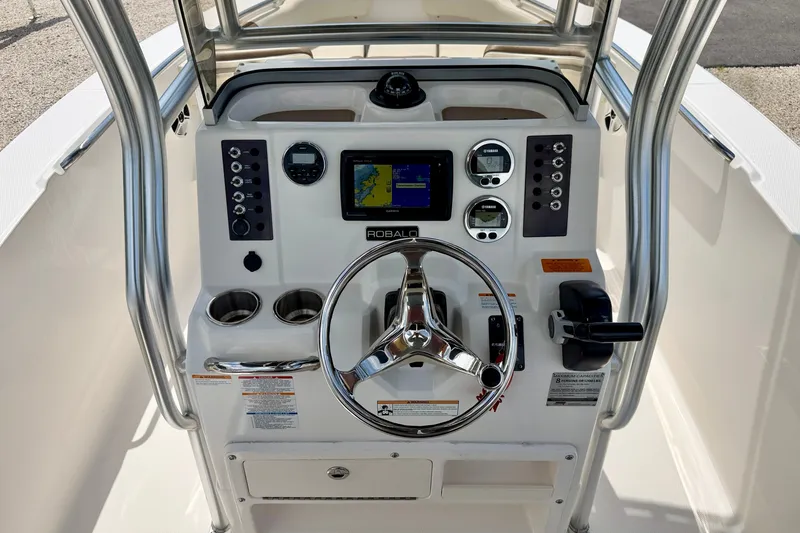 Slide: The Image of 2017 Robalo R200 Center Console boat dashboard with steering wheel and navigation controls. - 16