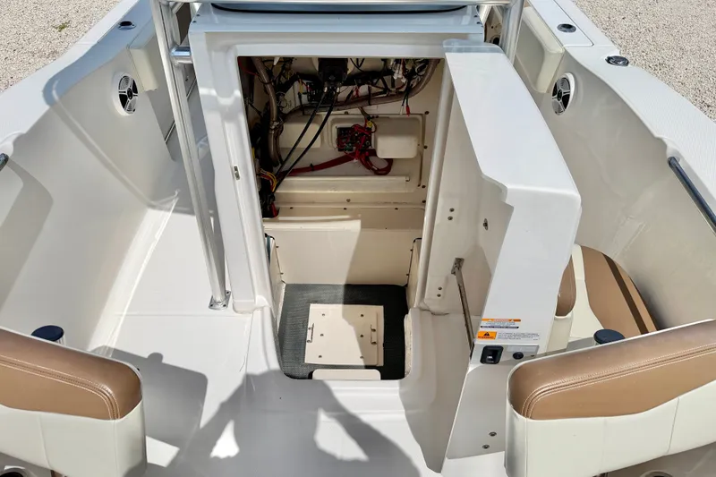 Slide: The Image of 2017 Robalo R200 Center Console boat interior with storage compartment and seating. - 27