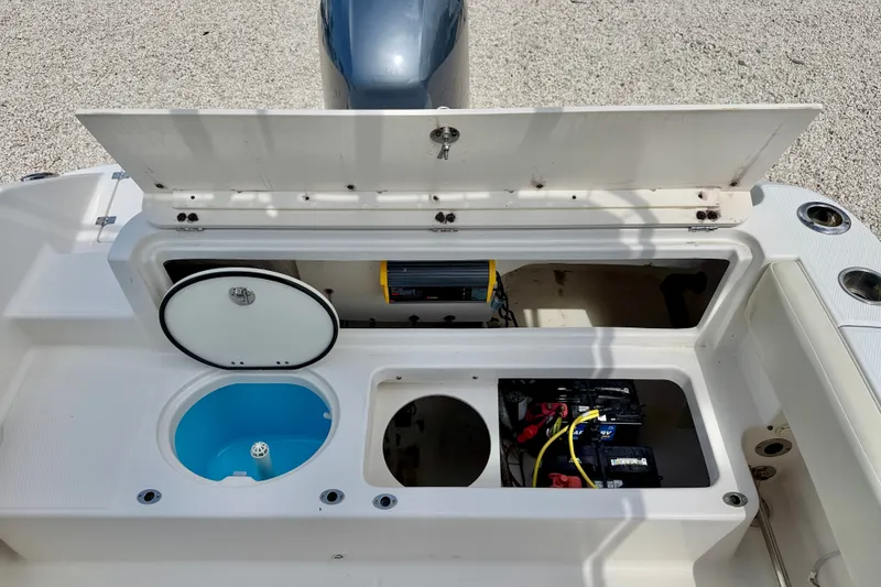 Slide: The Image of 2017 Robalo R200 Center Console boat storage compartments and battery setup. - 23