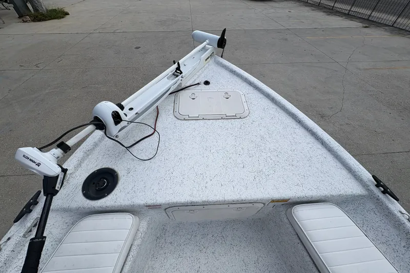 Slide: The Image of Bow view of a 2008 Kenner 19 VX boat with trolling motor and storage hatch. - 19